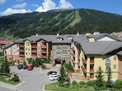 an aerial view of a resort with a parking lot at Fireside Lodge #413 By Bear Country in Sun Peaks