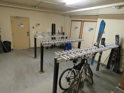 a room with a bike parked in a room at Fireside Lodge #409 By Bear Country in Sun Peaks