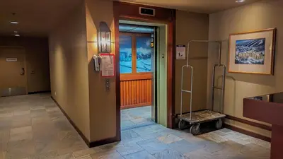 a hospital hallway with a door and a luggage cart at Holiday Home in Sun Peaks