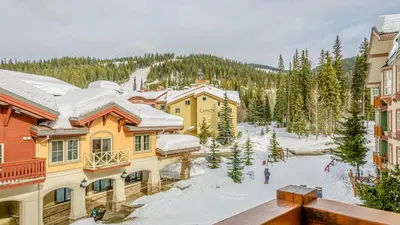 a view of a resort with snow covered buildings at Fireside Lodge #315 By Bear Country in Sun Peaks