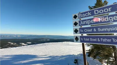 a sign at the top of a snow covered mountain at Woodhaven #36 By Bear Country in Sun Peaks