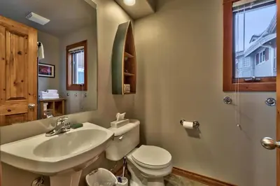 a bathroom with a white toilet and a sink at Timberline Village #14 By Bear Country in Sun Peaks