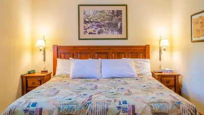 a bedroom with a bed with two night stands at Timberline Village #38 By Bear Country in Sun Peaks
