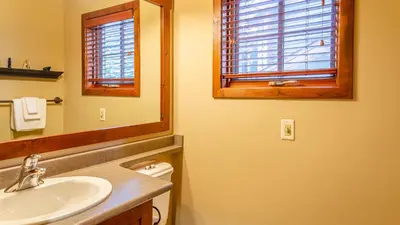 a bathroom with a sink and a mirror at Woodhaven #32 By Bear Country in Sun Peaks