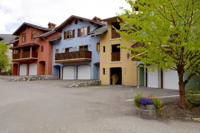 a large apartment building with a parking lot at Snow Creek Village #48 By Bear Country in Sun Peaks