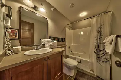 a bathroom with a sink and a toilet and a shower at Stones Throw #56 By Bear Country in Sun Peaks
