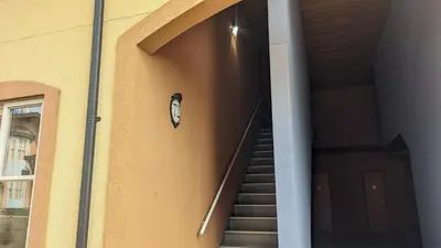 a clock on the side of a building with stairs at Crystal Forest #72 By Bear Country in Sun Peaks