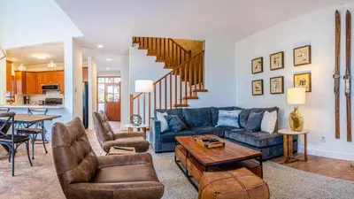 a living room with a blue couch and chairs at Trails Edge #25 By Bear Country in Sun Peaks