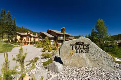a large rock with the words sun trails bbc on it at Trails Edge #17 By Bear Country in Sun Peaks