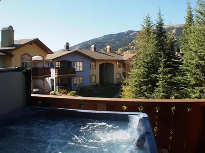 a hot tub on the balcony of a house at Crystal Forest #66 By Bear Country in Sun Peaks