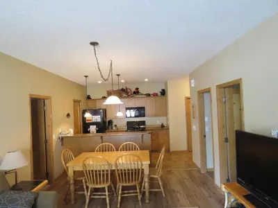 a dining room and kitchen with a table and chairs at Crystal Forest #63 By Bear Country in Sun Peaks