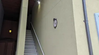 a clock on the side of a building with stairs at Crystal Forest #54 By Bear Country in Sun Peaks