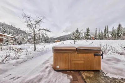 a container sitting on the side of a snow covered road at Crystal Forest #40 By Bear Country in Sun Peaks