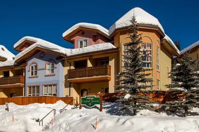 a house in the snow with a sign in front of it at Crystal Forest #40 By Bear Country in Sun Peaks