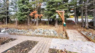 a wooden cross on a walkway in a park at Crystal Forest #11 By Bear Country in Sun Peaks