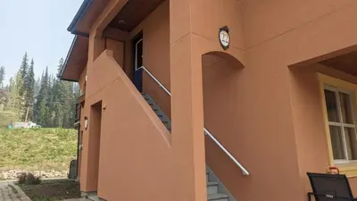 a clock on the side of a building with a staircase at Crystal Forest #22 By Bear Country in Sun Peaks