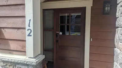 a wooden door of a house with a number on it at Stones Throw #12 By Bear Country in Sun Peaks