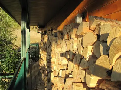 a wall of logs on the side of a building at Wild Nature B&B in Kelowna