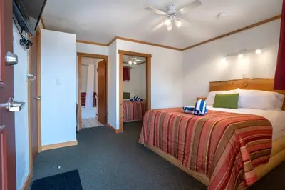a bedroom with a bed and a ceiling fan at Gateway Motel in Radium Hot Springs