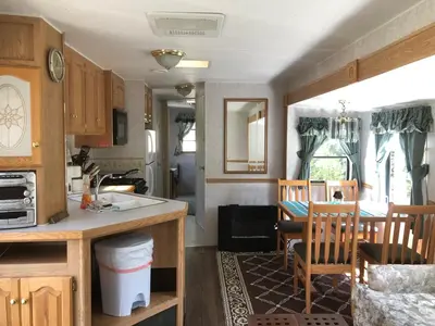 a kitchen with a sink and a table with a dining room at Garden Bay Hideaway - Glamping & RV in Garden Bay