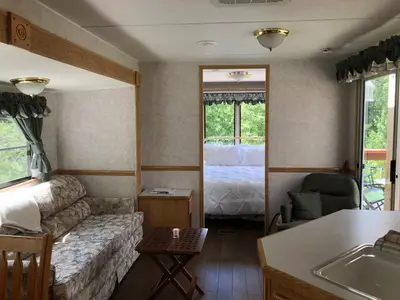a living room with a couch and a bed at Garden Bay Hideaway - Glamping & RV in Garden Bay