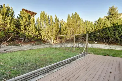 a wooden deck with a soccer goal in a field at Rodee Homestay in West Kelowna