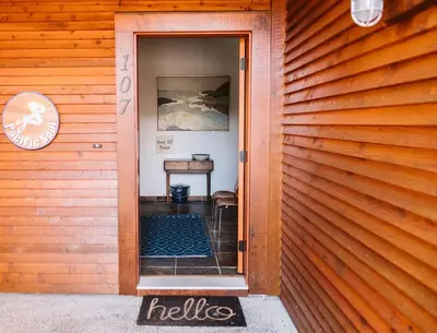 an open door to a room with a table at Pacific Soul Eco-Luxe Vacation Home in Ucluelet