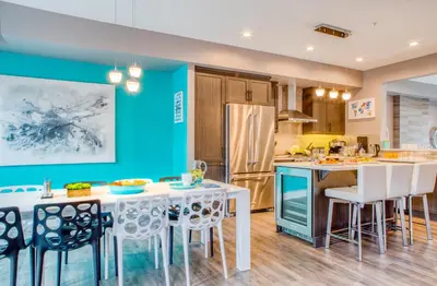 a kitchen with blue walls and a table and chairs at Nomad by Samsara Resort - Panorama Top View - 4BR & 5BTH in Canmore