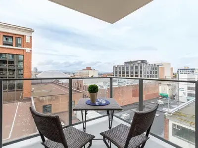 a balcony with a table and chairs and a view at City Centre in Victoria