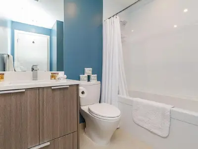 a bathroom with a toilet and a sink and a tub at City Centre in Victoria