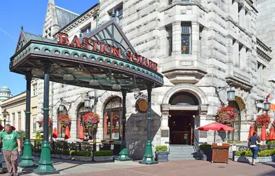 a man standing in front of a building at 5 Min Walk To Famous Victoria Inner Harbour And Empress Hotel in Victoria