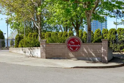 a sign on a brick wall next to a sidewalk at Deluxe 2 Bed 2 Bath And 5 Min Walk To Downtown And Seawalk in Victoria