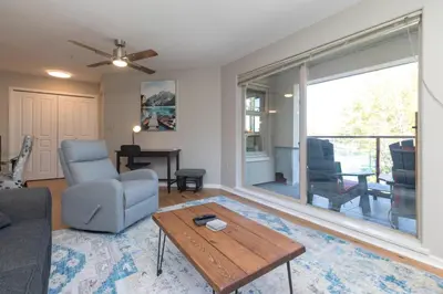 a living room with a couch and a table at Deluxe 2 Bed 2 Bath And 5 Min Walk To Downtown And Seawalk in Victoria