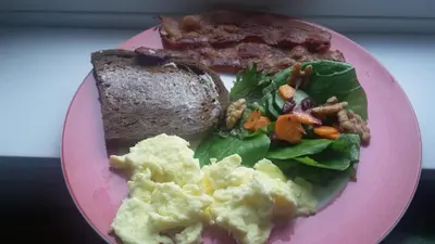 a pink plate of food with breakfast foods on it at Vancouver Traveller B&B in Vancouver