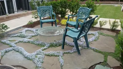 two blue chairs sitting next to a fountain at Vancouver Traveller B&B in Vancouver