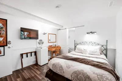 a bedroom with a bed and a desk at Along River Ridge in Calgary