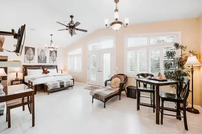 a bedroom with a bed and a table and chairs at Along River Ridge in Calgary
