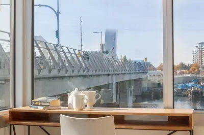 a desk with a view of a bridge from a window at Enjoy The Waterway Action At Your Doorstep in Victoria