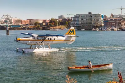 a small plane and a man in a boat in the water at Enjoy The Waterway Action At Your Doorstep in Victoria