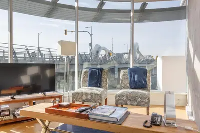 a living room with a table and chairs and a large window at Enjoy The Waterway Action At Your Doorstep in Victoria