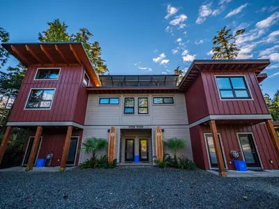 a house with red and white at The Cabins at Terrace Beach in Ucluelet