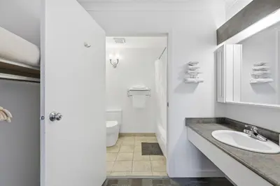 a white bathroom with a sink and a toilet at Lillooet Hotel Victoria in Lillooet