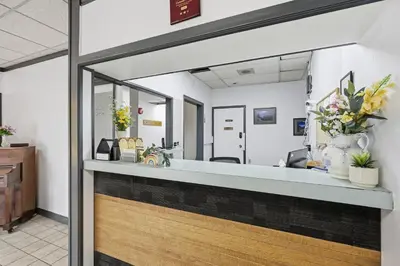 a reception desk in a dental office with flowers at Lillooet Hotel Victoria in Lillooet