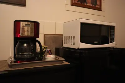 a microwave sitting on top of a counter with a coffee maker at Vista Motel in Vegreville