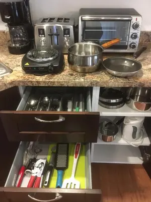 a kitchen counter with a sink and a microwave at Oceanspray Hideaway in North Saanich