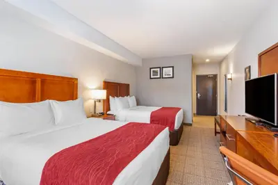 a hotel room with two beds and a flat screen tv at Comfort Inn & Suites in Valemount