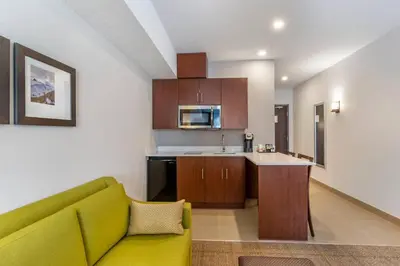 a living room with a couch and a kitchen at Comfort Inn & Suites in Valemount