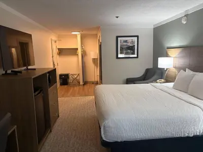 a hotel room with a bed and a television at Quality Inn & Suites in Whitehorse