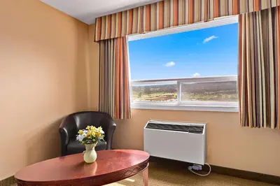 a room with a table and a window at Coast Fraser Inn in Williams Lake