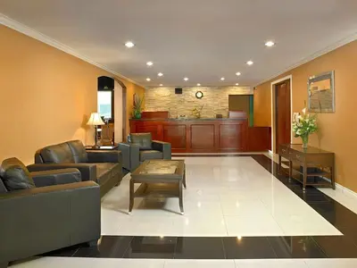 a living room with couches and a waiting room at Coast Fraser Inn in Williams Lake